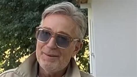 Ein Neugeborenes mit schöner Haarpracht, das sanft von der Mutter gebürstet wird.