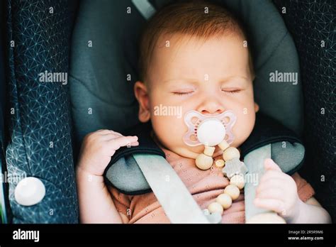 Illustration eines Babys, das friedlich schläft, umgeben von beruhigenden Elementen wie einem Schnuller und einem Kuscheltuch.
