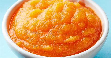 Illustration eines Babys, das mit Begeisterung Karottenbrei isst.