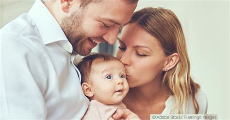 Frau mit Baby im Arm, die positiv in die Zukunft blickt