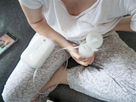 Frau pumpt Milch mit einer elektrischen Milchpumpe