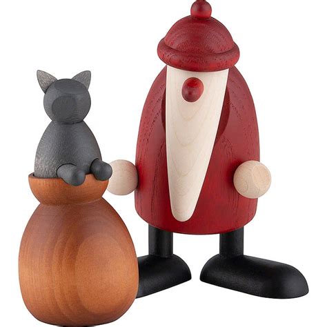 Collage verschiedener Weihnachtsmann-Figuren von Björn Köhler, darunter der mit Dackel und der mit Katze